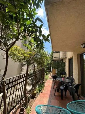 a patio with tables and chairs on a balcony at Bono Apartments in Budva