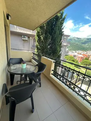 a balcony with a table and chairs and a view at Bono Apartments in Budva