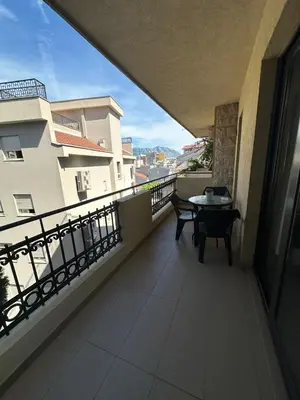 a balcony with a table and a view of a city at Bono Apartments in Budva