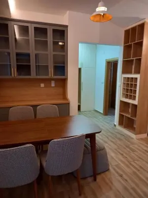 a dining room with a wooden table and chairs at Apartman Borka Rezevici in Krstac
