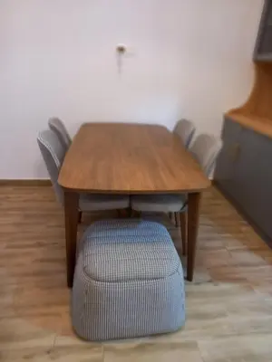 a wooden table and chairs with a chair around it at Apartman Borka Rezevici in Krstac