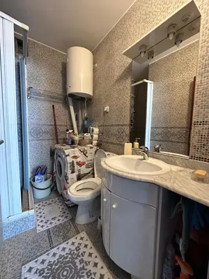 a bathroom with a toilet and a sink and a mirror at Apartment Mediteraneo in Budva
