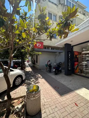 a white car parked in front of a building at Apartment Mediteraneo in Budva