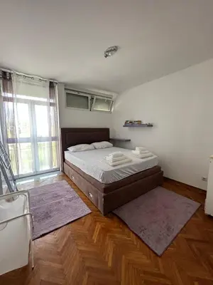a bedroom with a bed and a large window at Apartment Mediteraneo in Budva