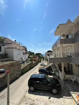 a black car parked on a street next to a building at Pushime te Daka in Ulcinj