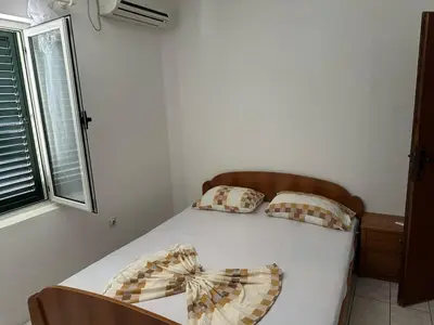 a bed with two pillows and a bow on it at Pushime te Daka in Ulcinj
