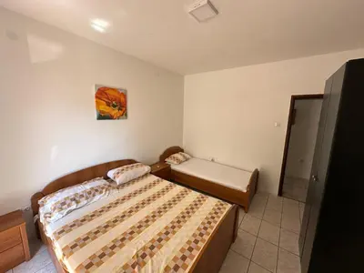 a small bedroom with a bed and a mirror at Pushime te Daka in Ulcinj