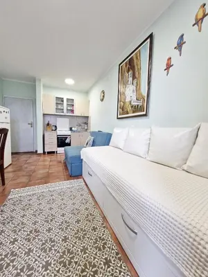 a bedroom with a bed and a living room at Ilino Studio Apartment in Bar
