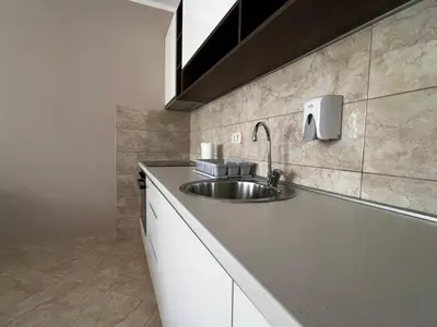 a kitchen with a sink and a counter top at Apartment Zevs Bečići in Kravlja