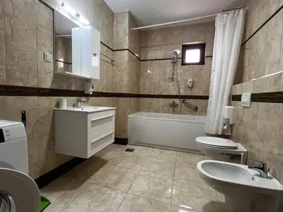 a bathroom with a tub and a sink and a toilet at Apartment Zevs Bečići in Kravlja