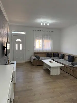 a living room with a couch and a table at Lukic Guest house in Ulcinj