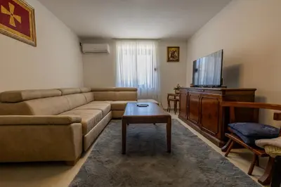 a living room with a couch and a flat screen tv at Wild silence - Skadar Lake in Virpazar