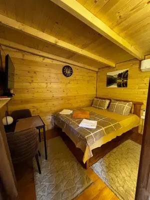 a bedroom with a bed in a log cabin at Brvnara Toma in Cetinje