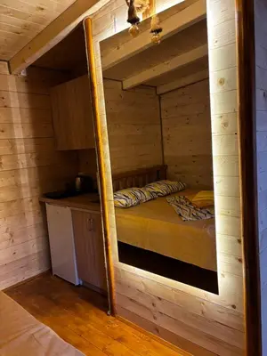 a room with a bed in a wooden cabin at Brvnara Toma in Cetinje