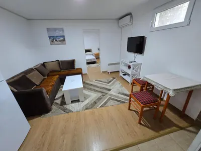 a living room with a couch and a table at Apartman Knez 1 in Podgorica