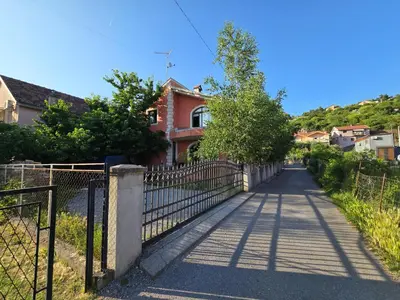 a fence in front of a house at Apartman Knez 1 in Podgorica