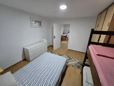 a room with a bed and a dresser and a bedroom at Apartman Knez 1 in Podgorica