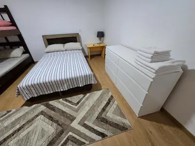 a room with a bed and a table with towels at Apartman Knez 1 in Podgorica