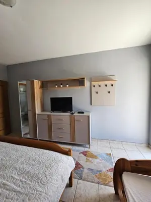 a bedroom with a bed and a tv on a wall at Villa Linna in Budva