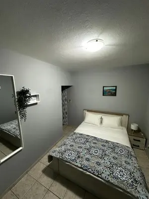 a bedroom with a bed and a mirror at Villa Linna in Budva