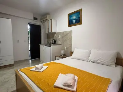 a bedroom with a bed with two towels on it at RZ apartment in Budva
