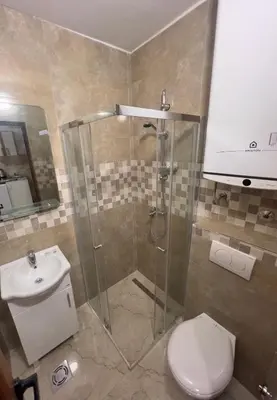 a bathroom with a shower and a toilet and a sink at RZ apartment in Budva