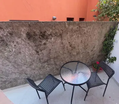 a patio with two chairs and a table at RZ apartment in Budva