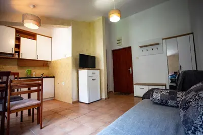a room with a kitchen and a living room at студия солнце in Budva