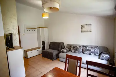a living room with a couch and a table at студия солнце in Budva