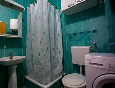 a bathroom with a toilet and a sink and a shower at студия солнце in Budva