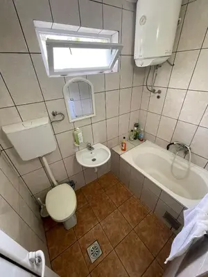 a bathroom with a toilet and a sink and a tub at Cool room in Authentic Montenegro House in Ulcinj