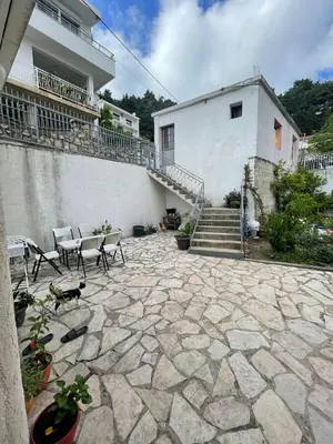 a patio with a table and chairs in front of a building at Cool room in Authentic Montenegro House in Ulcinj