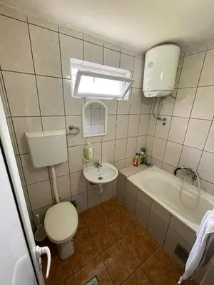 a bathroom with a toilet and a sink and a tub at Cool room in Authentic Montenegro House in Ulcinj