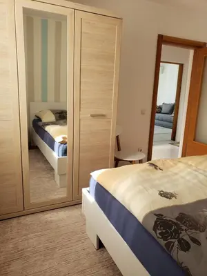 a bedroom with a bed and a large mirror at Уютная квартира в частном секторе , идеальный отдых у моря in Bar