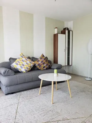 a living room with a couch and a table at Уютная квартира в частном секторе , идеальный отдых у моря in Bar