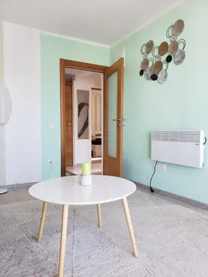 a white table in a room with a blue wall at Уютная квартира в частном секторе , идеальный отдых у моря in Bar