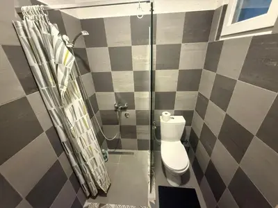 a bathroom with a toilet and a glass shower at Studio apartament Vukcevic 2 in Golubovci