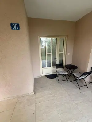 a room with two chairs and a sign on the wall at Studio apartament Vukcevic 2 in Golubovci