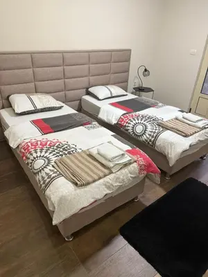 two beds sitting next to each other in a bedroom at Studio apartament Vukcevic 2 in Golubovci