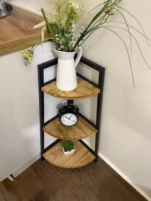 a vase sitting on top of two wooden shelves at Studio apartament Vukcevic 2 in Golubovci