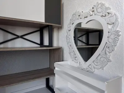 a mirror in the shape of a heart on a shelf at Studio 89 in Burtaiši