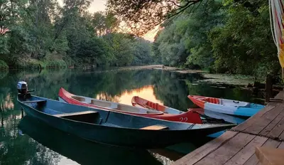 a group of boats are docked on a river at Whispering Waters