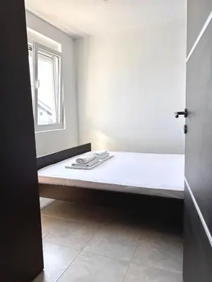 a bed in a room with a window at Lotus in Donji Štoj