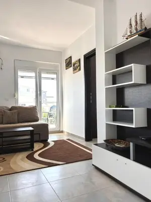 a living room with a couch and a table at Lotus in Donji Štoj