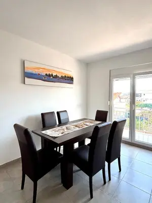 a dining room with a table and chairs at Lotus in Donji Štoj