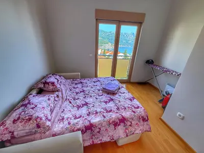 a bedroom with a bed with a pink blanket at Jelena apart Budva in Becici