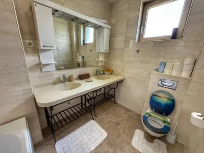 a bathroom with a sink and a mirror and a toilet at Jelena apart Budva in Becici