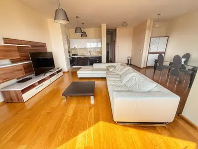 a living room with a white couch and a tv at Jelena apart Budva in Becici