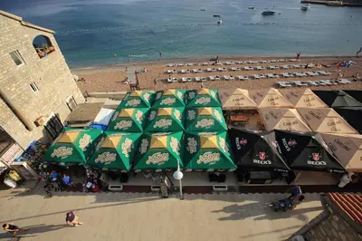 an overhead view of a beach with umbrellas at Galija lux Petrovac in Petrovac na Moru