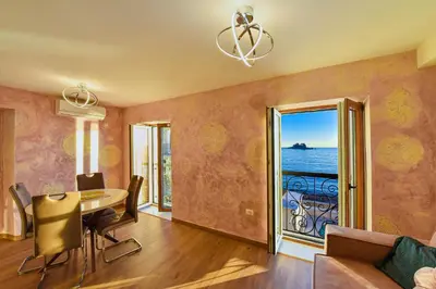 a dining room with a table and a view of the ocean at Galija lux Petrovac in Petrovac na Moru